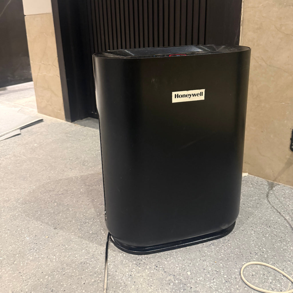 Black humidifier on a tiled floor
