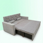 Gray sectional sofa with pull-out bed mechanism on a light green background