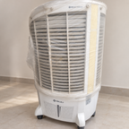 Pre-owned white Bajaj desert cooler with plastic wrapping and visible wear