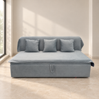 Blue-grey sofa cum bed in sofa configuration in a softly lit neutral room
