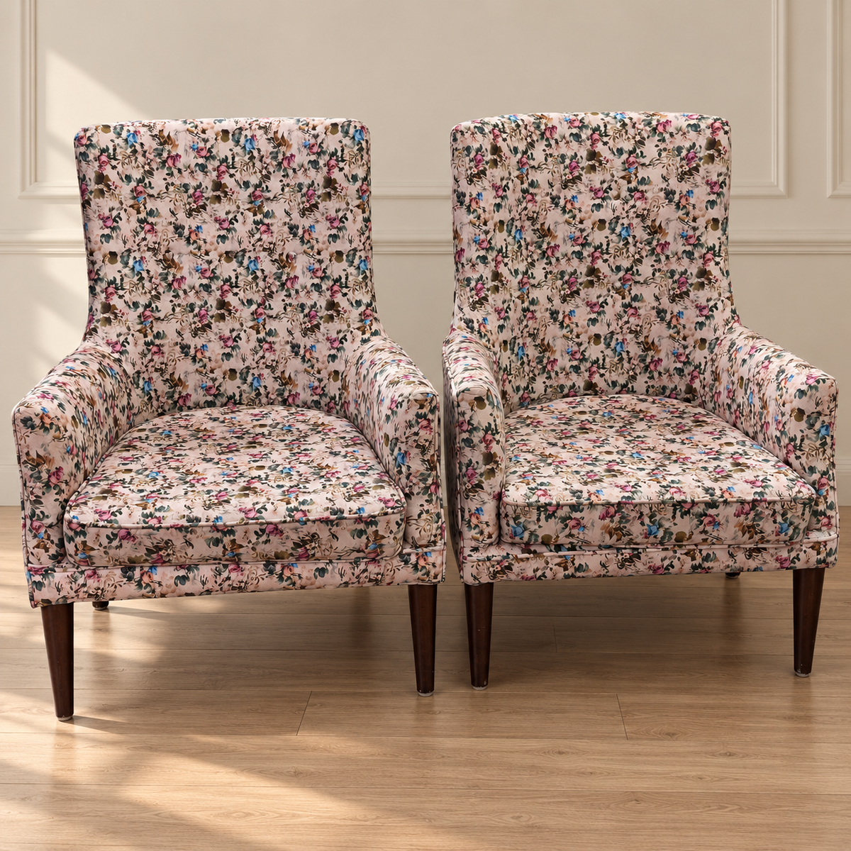 Pair of pre-owned floral upholstered wingback lounge chairs in neutral room