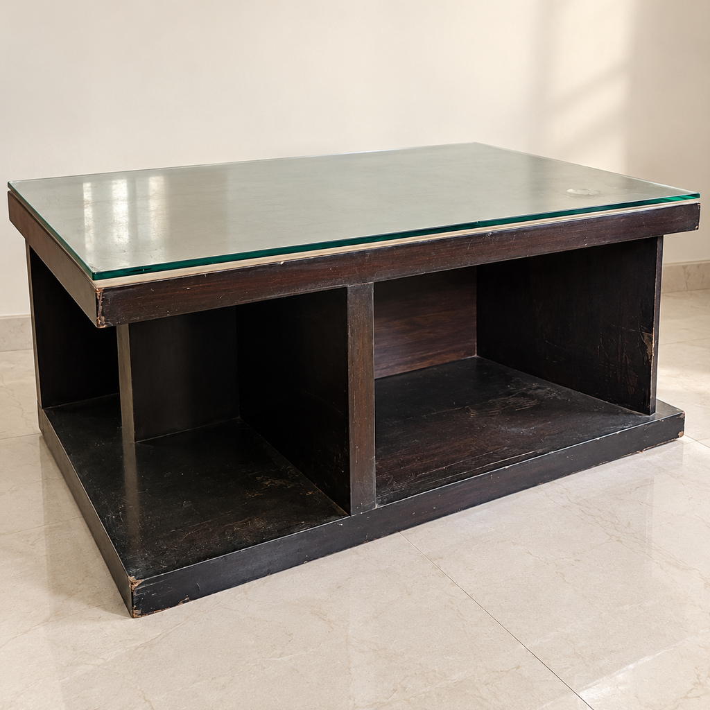 Urban Ladder glass-top coffee table with visible wear