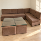 Brown L-shaped sofa with glass-top table and 4 storage seats - Gurugram