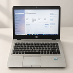 Pre-owned silver HP EliteBook laptop with visible cosmetic wear