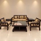 Five-seat dark wood sofa set and glass-top tables in a neutral room