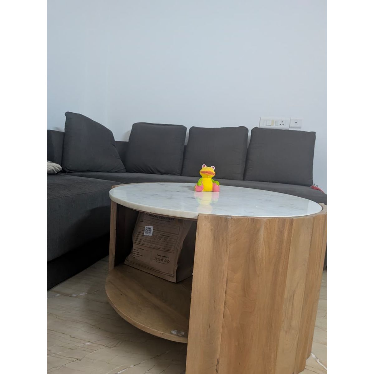 Round center table with marble top and natural wood base